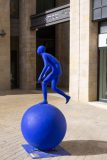 A blue man on a street corner in Jerusalem